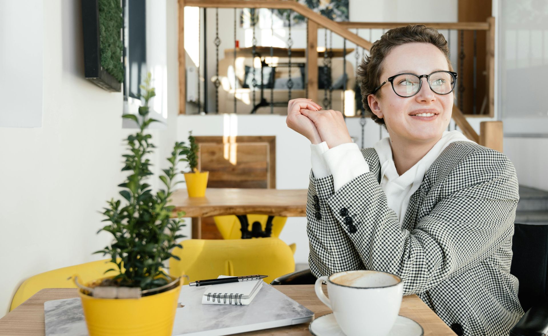 Smiling disabled female remote worker at table in coffee shop