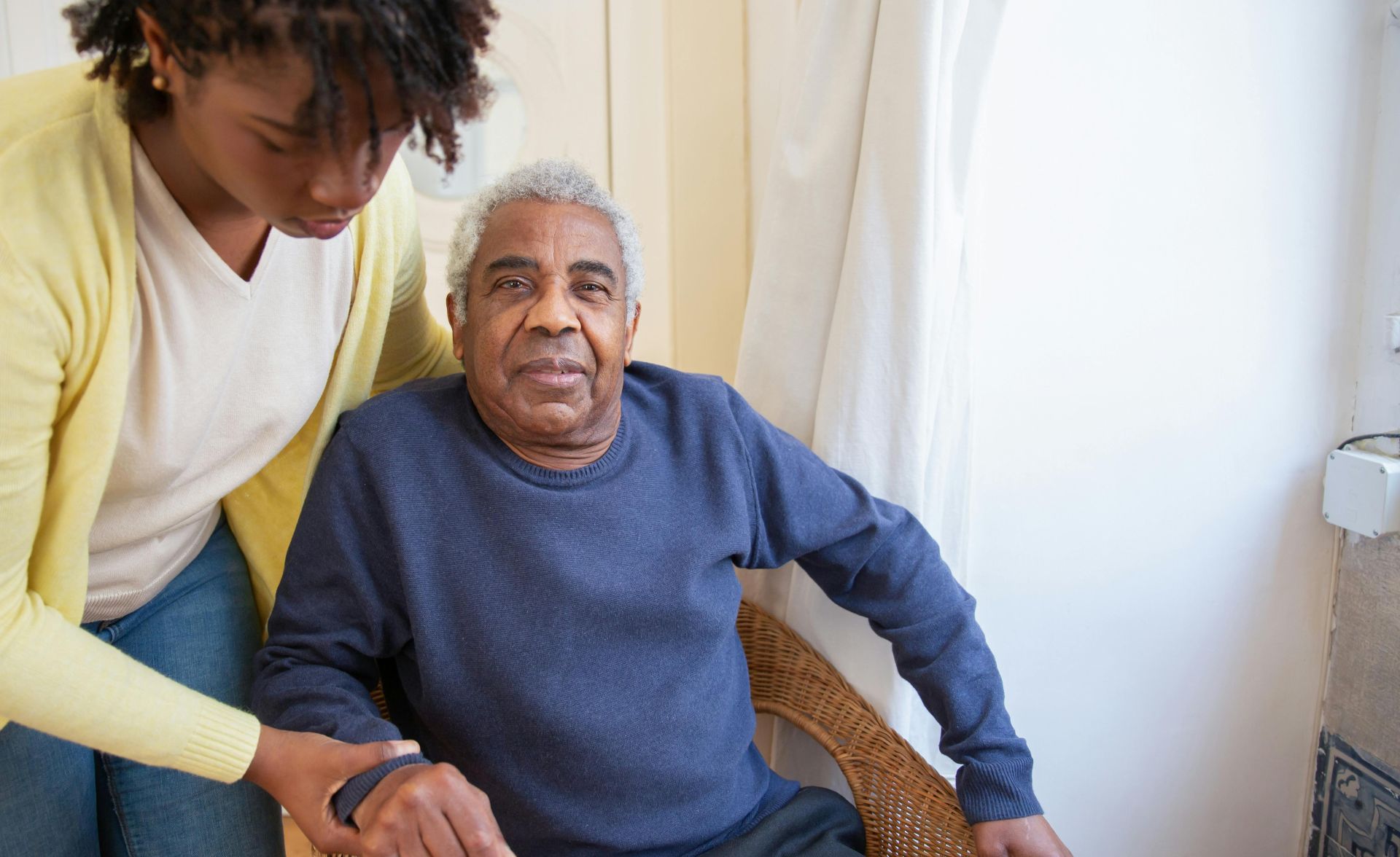 Woman Assisting Elderly Man